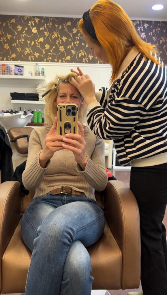 sophies.model sitting in the hairdresser chair while Marietta is working her magic to create a 60's style hair.