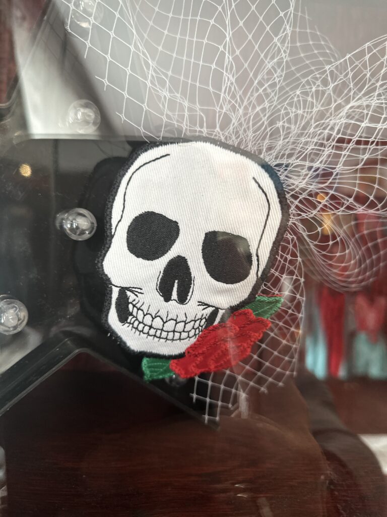 Stylish hat with a skull figure on it displayed in the designer's shop.