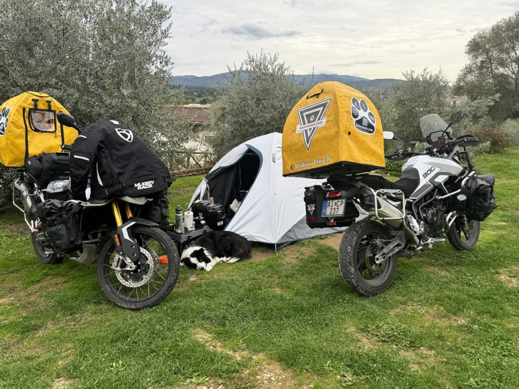 Tent set up and surrounded by the motorbikes, while Ricky is sleeping in front of the tent.