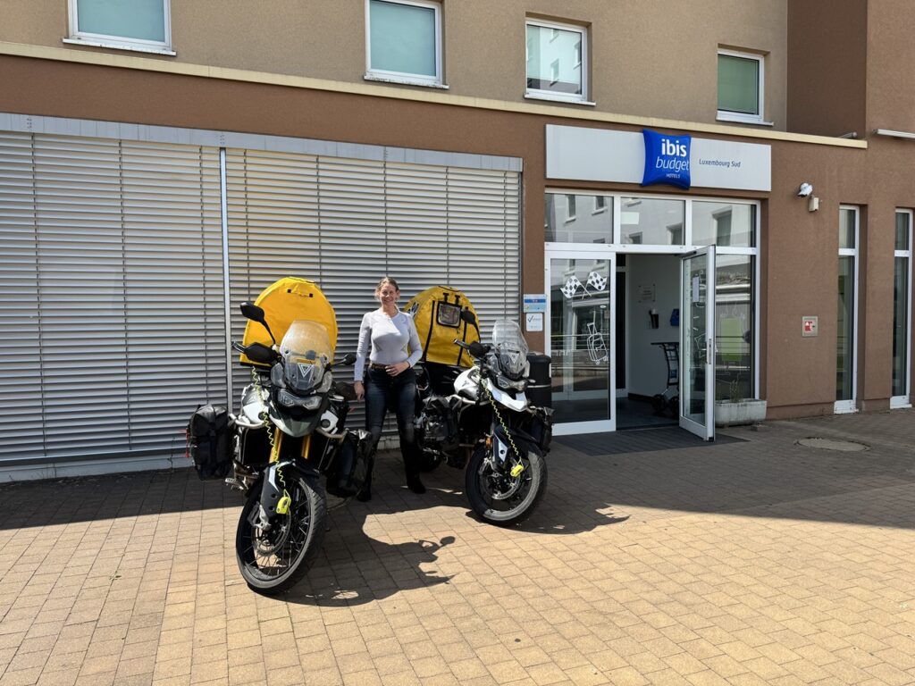 Zsófi pózol a leparkolt motorok mellett a luxemburgi ibis előtt.